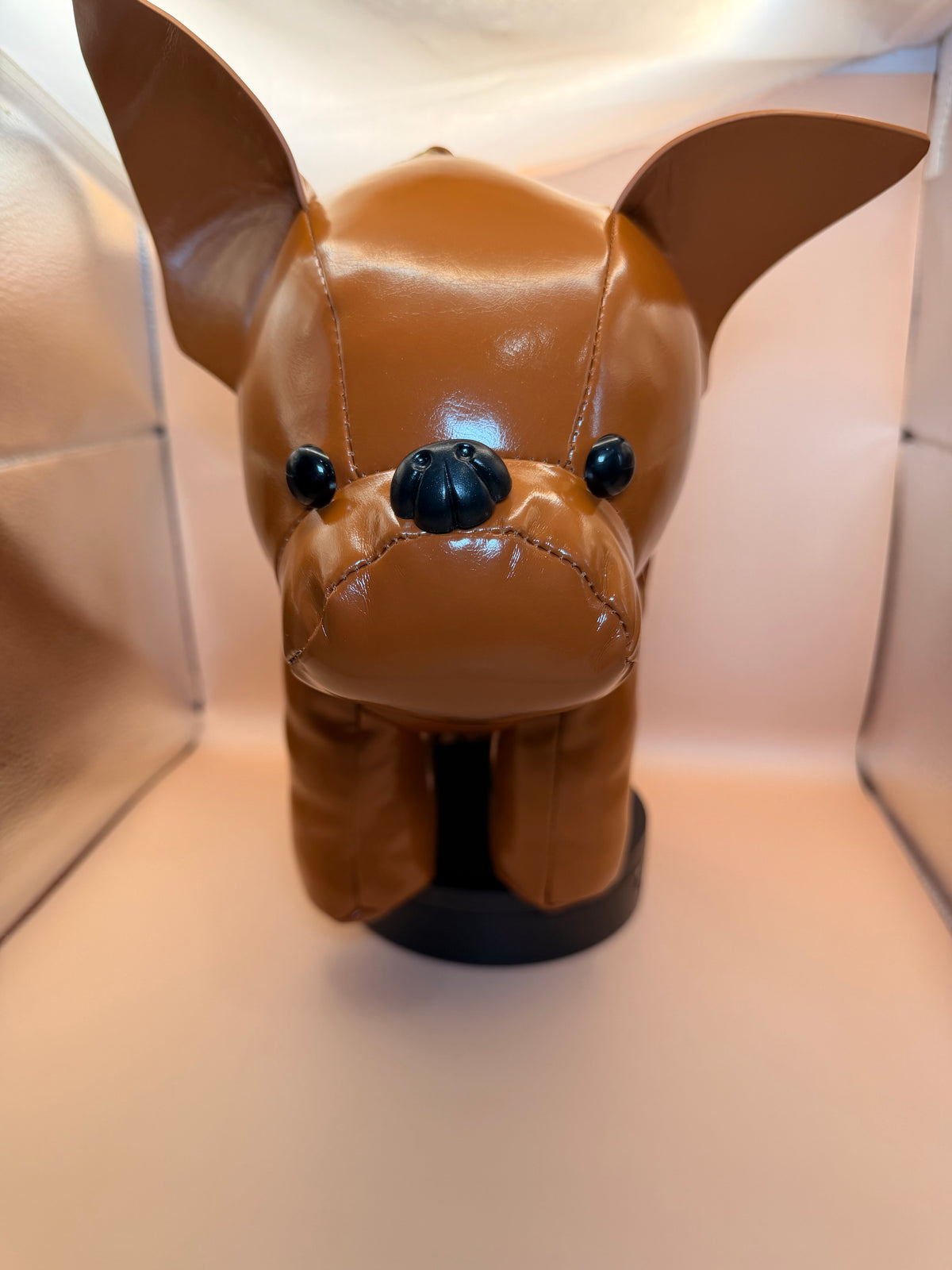 A glossy brown dog-shaped handbag