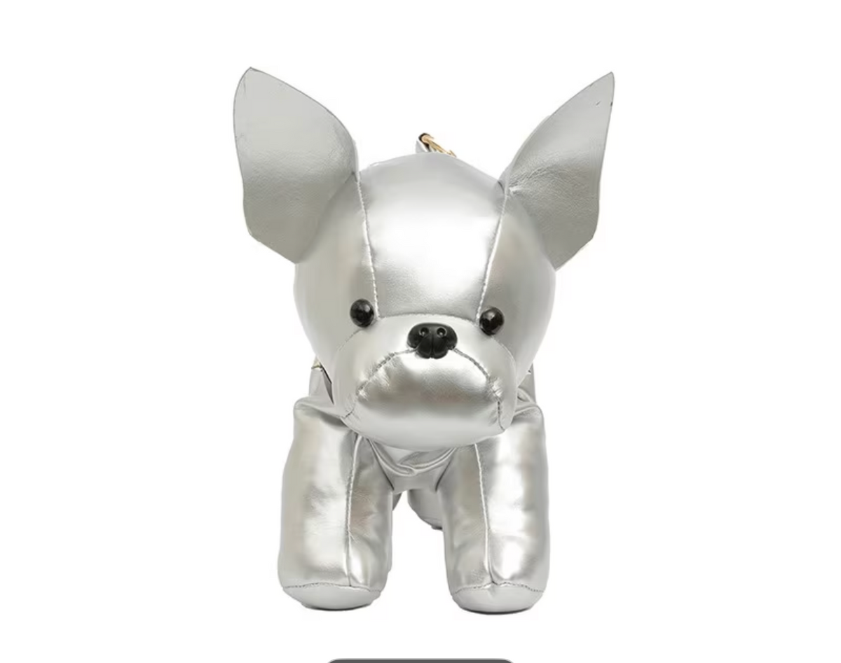 A silver metallic plush dog toy with black eyes and nose, shown on a white background with a 'Color: Silvery' label. The image is a screenshot from a shopping app with black bars and payment buttons visible.